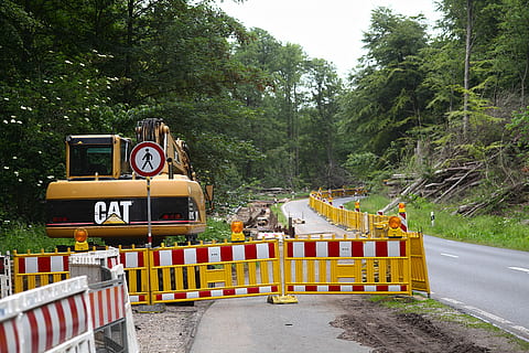 yellow excavator on side of road inside yellow barrier at daytime HD wallpaper