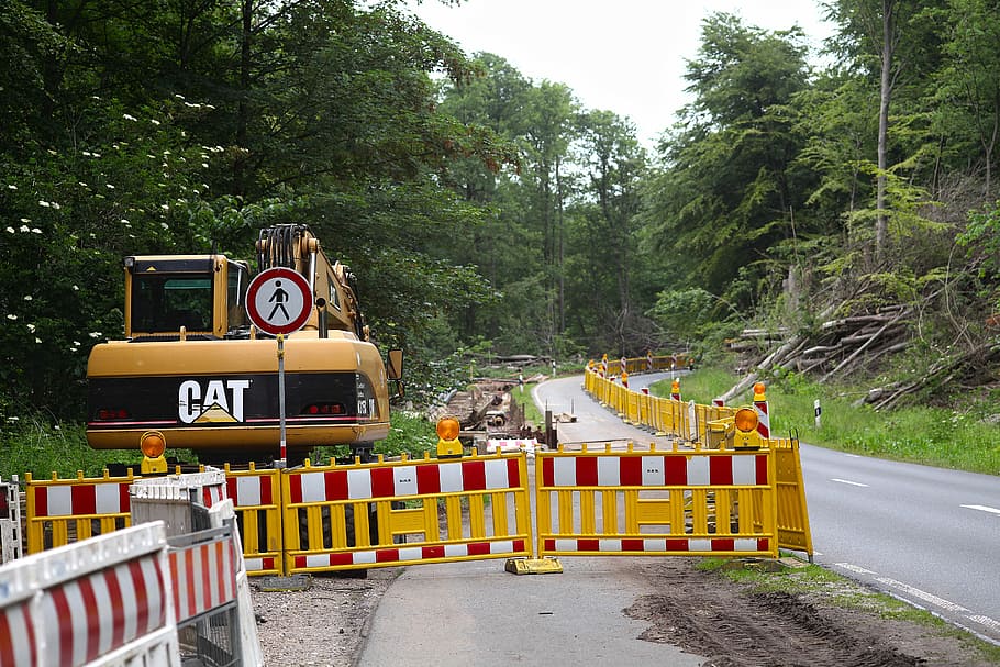yellow excavator on side of road inside yellow barrier at daytime HD wallpaper