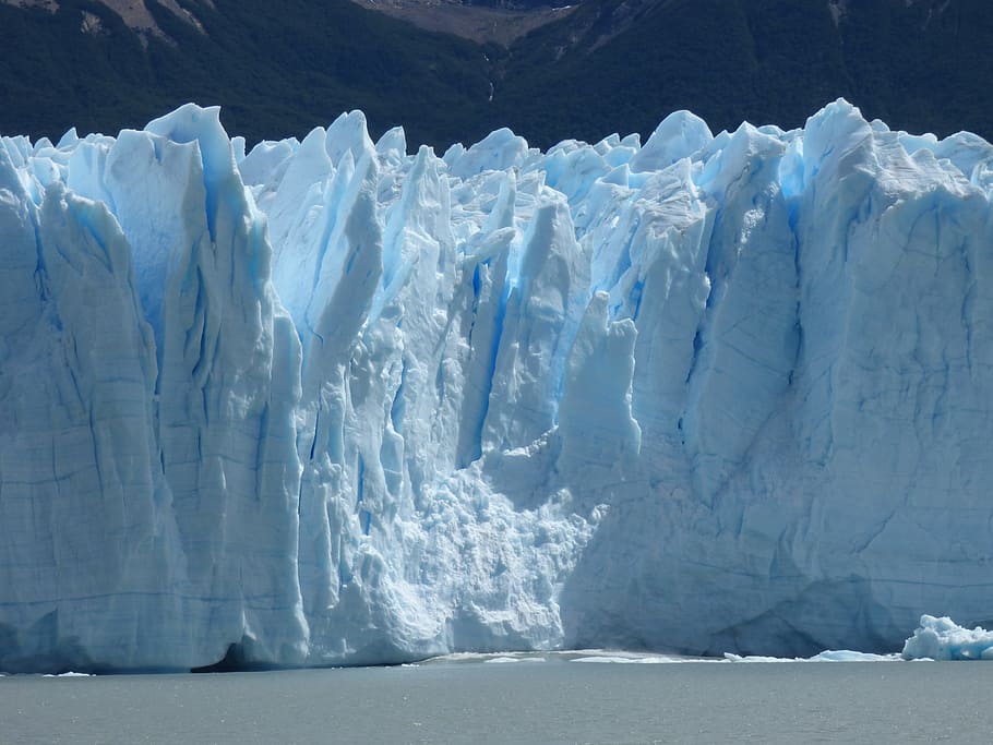 frozen tundra near body of water during day, Perito Moreno Glacier
