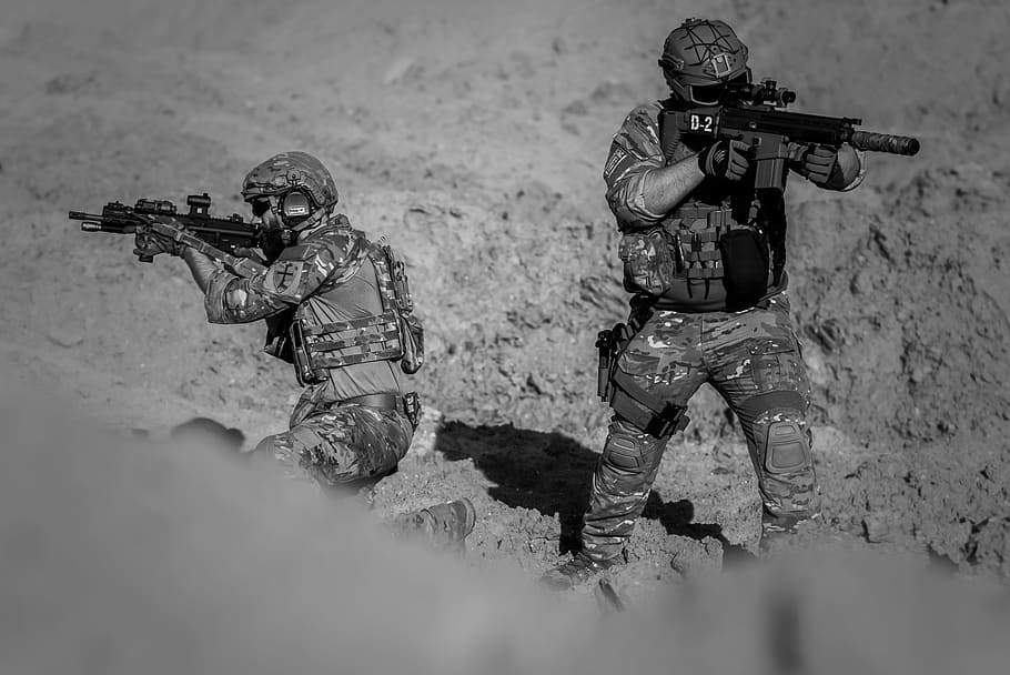 grayscale photo of two armies, war, desert, guns, gunshow, soldier