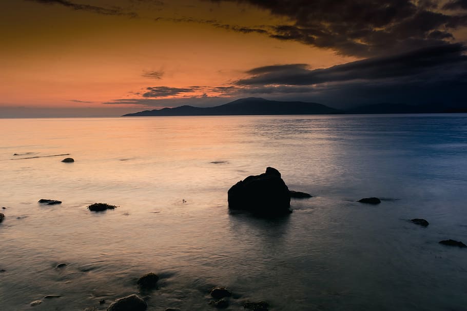silhouette painting of mountain, rock, calm, sea, sunset, dusk HD wallpaper