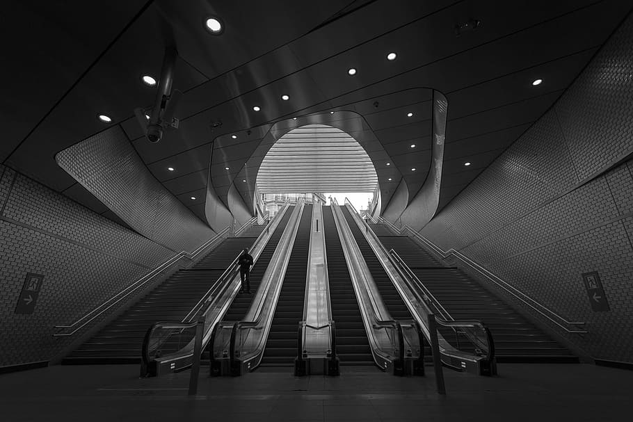 grayscale photography of person on escalator, low angle photography of escalator HD wallpaper