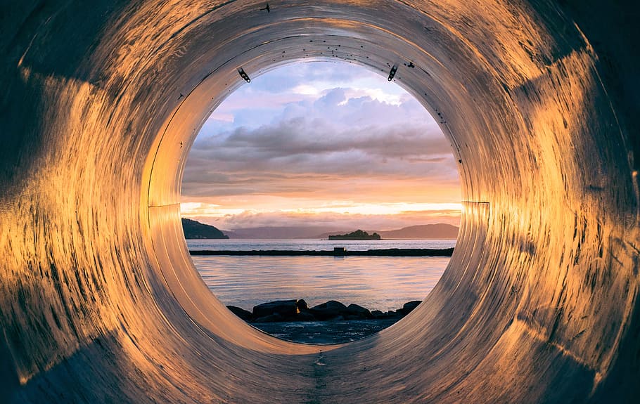 inside the hole photo of body of water during sunset, tube, pipe