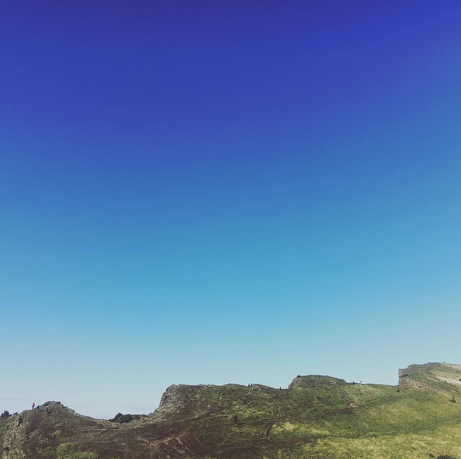 green and brown mountain under clear sky during daytime, green hills under blue skies at daytime HD wallpaper