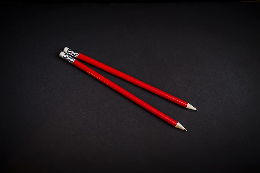 Red, two red pencils on black panel, writing implement, minimal