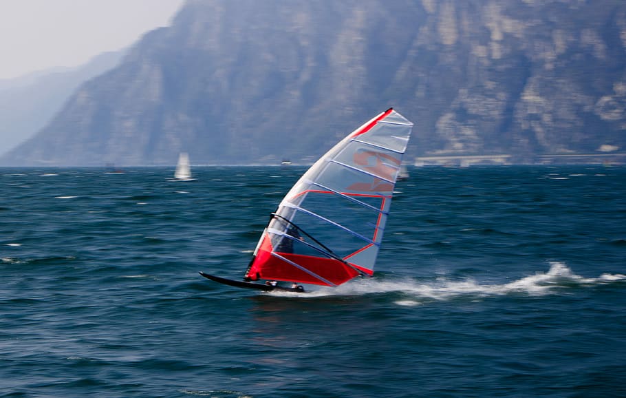 person windsurfing in body of water, mountain, sea, ocean, windsurfer