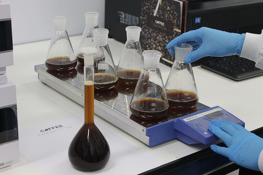 person holding clear glass laboratory flasks, coffee, caffeine HD wallpaper