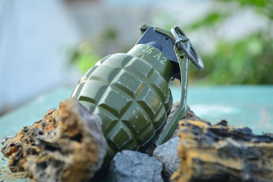 green frag grenade on brown rock, Nikon, sport, focus on foreground, HD wallpaper
