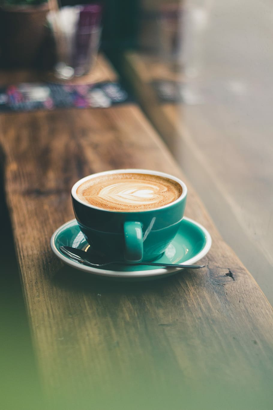 green ceramic cup on saucer, tilt-shift photography of cappuccino in teal coffee mug HD wallpaper