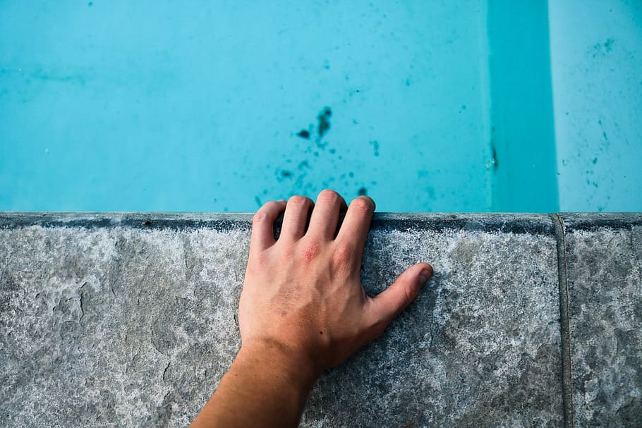 person's left hand holding gray concrete surface, person showing left hand HD wallpaper