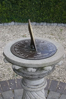 grey and brown sun dial near green leafed plants, sundial, time HD wallpaper