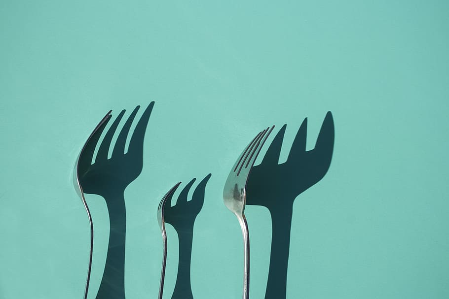 three gray metal forks casting shadow on green surface, stainless steel forks HD wallpaper