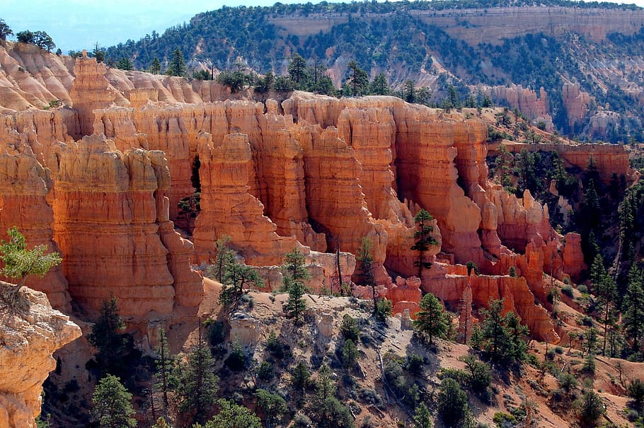 rock formations near green leafed trees, aerial photo of rock formation background of mountain at daytime HD wallpaper