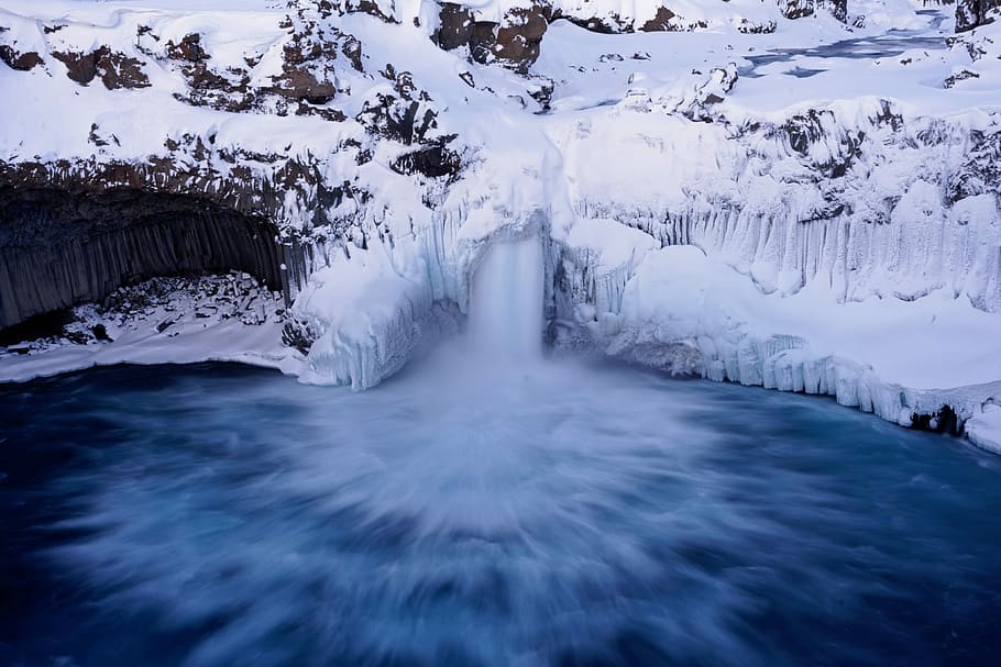 body of water across snow mountain, flowing river near snow field HD wallpaper