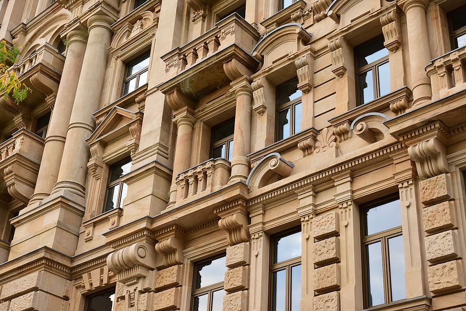 low angle photo of brown painted high rise building, concrete brown building HD wallpaper