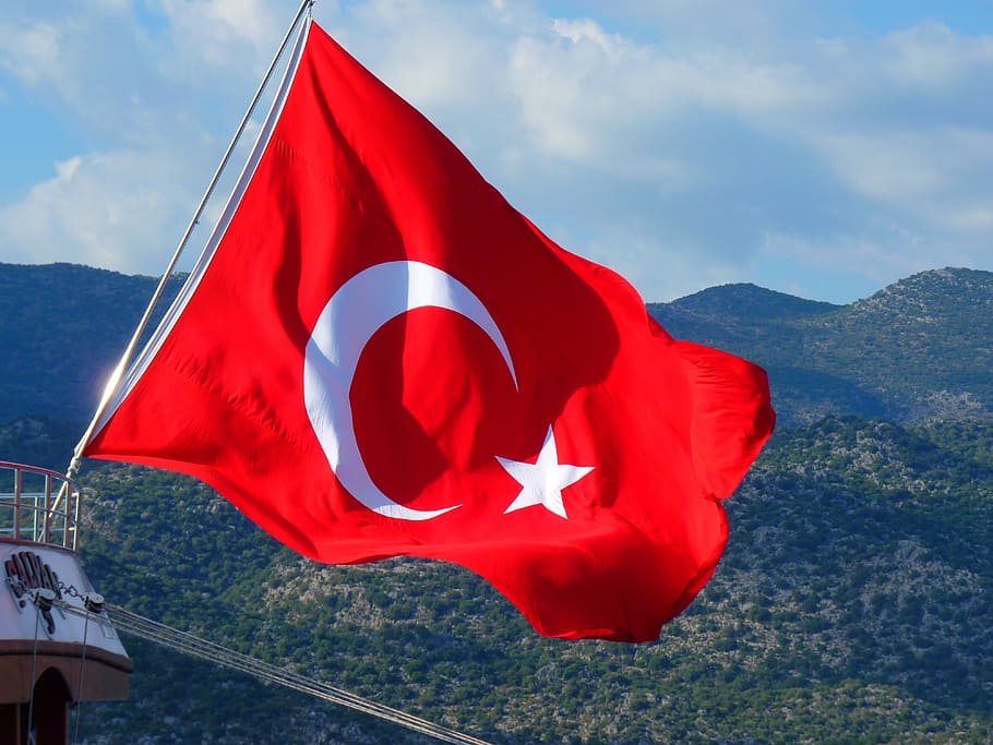 Turkey flag in front of green mountains during daytime, Turkish