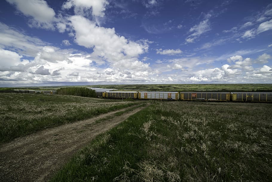 Train under the clouds and sky in Saskatchewan, grass, landscape HD wallpaper