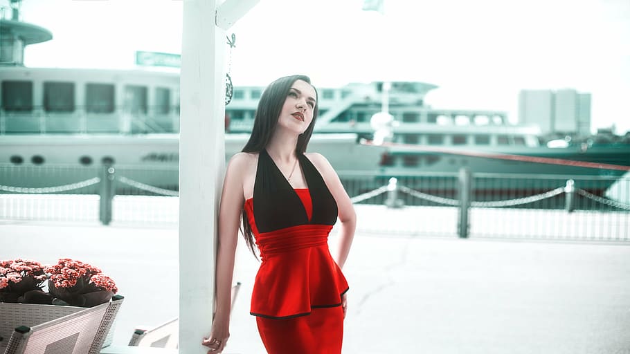 woman wears red and black sleeveless dress, girl, in a red dress