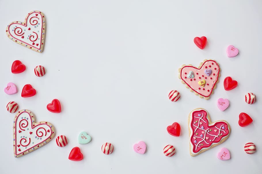 Overhead shot of love hearts and Valentine’s Day treats, various