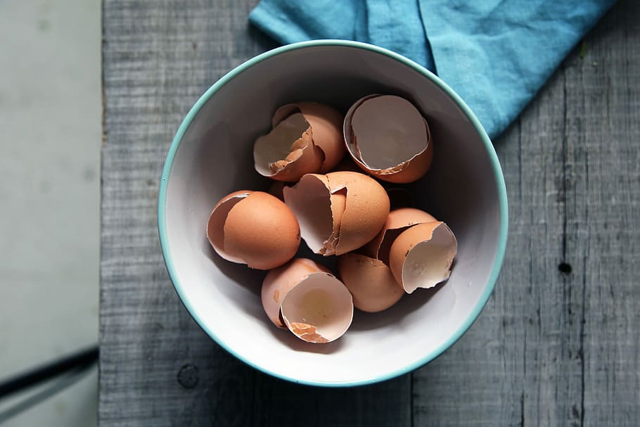 brown eggshells in round white ceramic bowl on gray wooden board top-view photography, egg shells in ceramic bowl, HD wallpaper