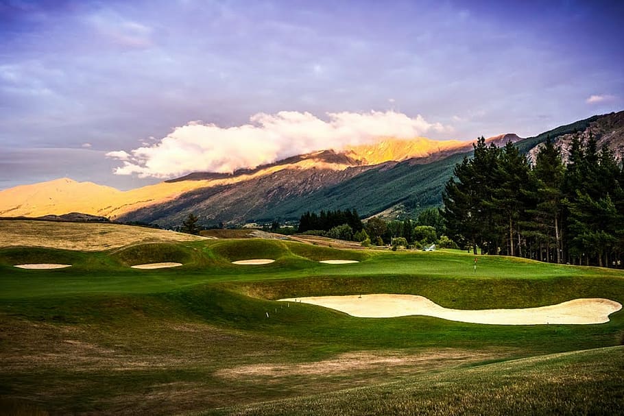 mountain and tree under blue sky at daytime, hills golf course