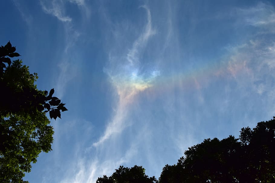 blue sky and white clouds, fire rainbow in the clouds, rare, early evening