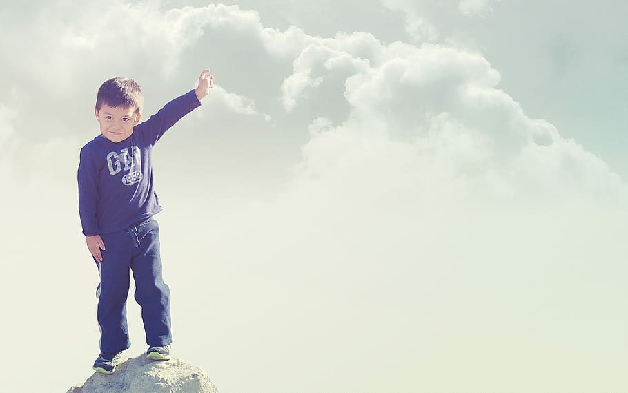 boy in black Gap sweatshirt and black bottoms standing on top of he cliff HD wallpaper