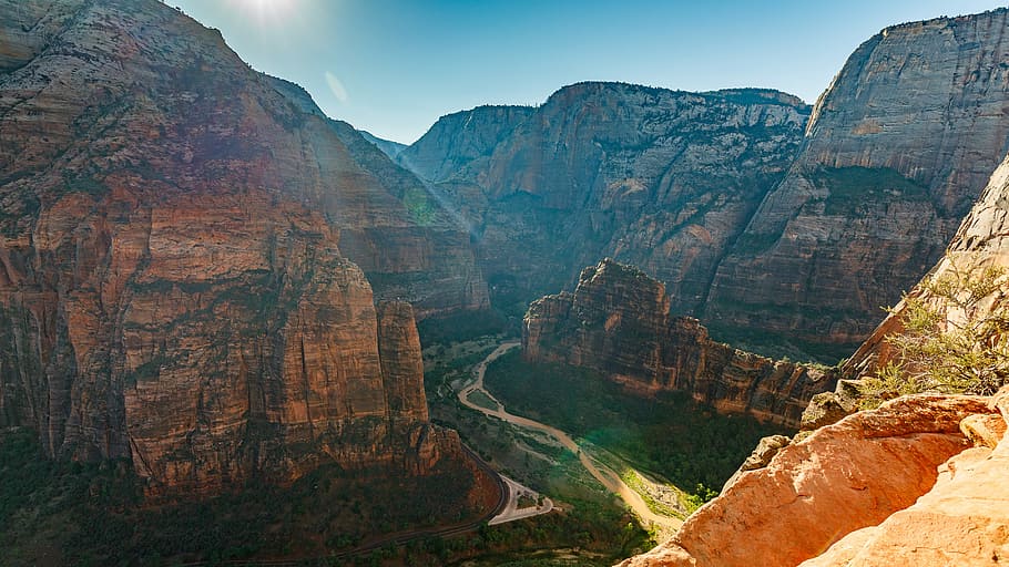 brown and black rugged mountain at daytime, brown rock formation mountains under blue sky HD wallpaper