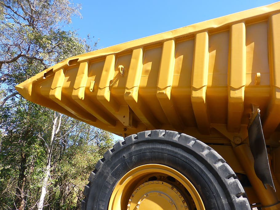 yellow haul truck parked next to tall trees, dump, tipper, dumper HD wallpaper