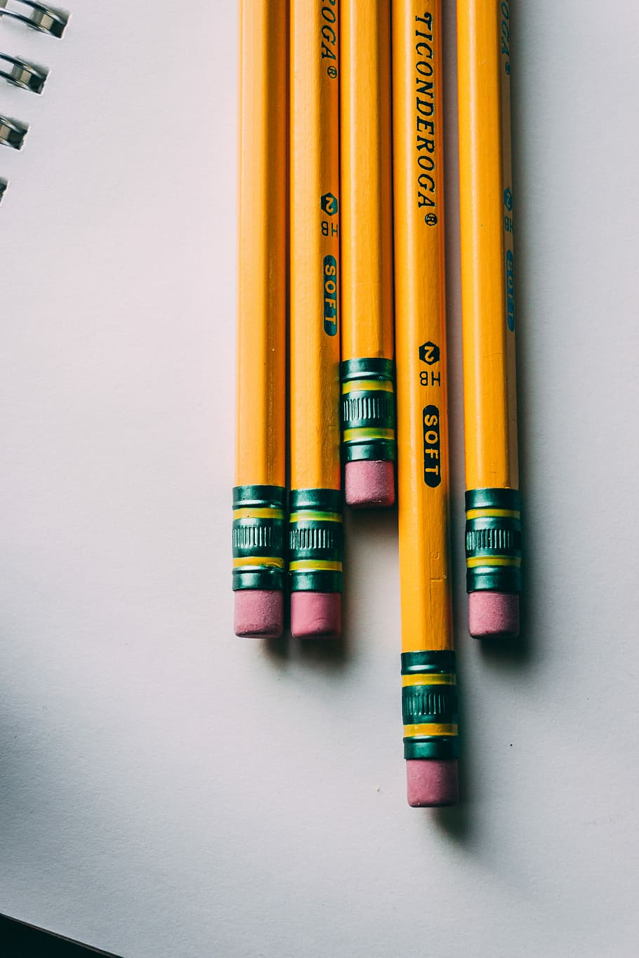 five brown pencils, five yellow Ticonderoga pencils on white spiral notebook close-up photography HD wallpaper