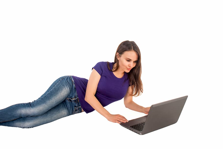 woman in purple shirt holding gray laptop computer, notebook