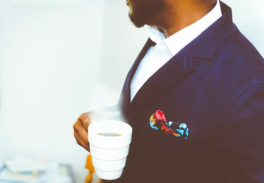 man holding white ceramic mug with coffee, man wearing black suit holding white mug with coffee HD wallpaper
