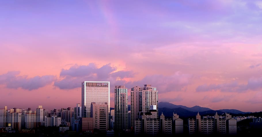 city buildings under cloudy sky, aerial photo of urban city under purple sky at daytime HD wallpaper