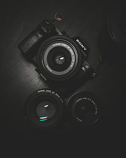 flat lay photography of black Sony DSLR camera on black surface, black Sony camera on board HD wallpaper