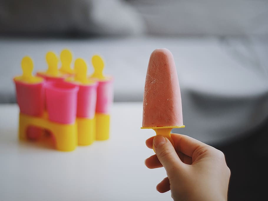 person holding Popsicle ice cream, person holding pink icicle HD wallpaper