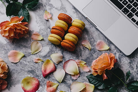 Overhead view of macarons on a marble slab, roses, workspace HD wallpaper