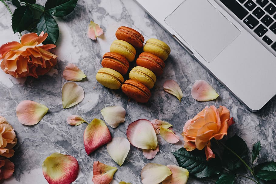 Overhead view of macarons on a marble slab, roses, workspace HD wallpaper