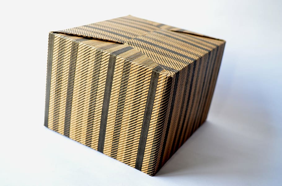 brown and black labeled box on white surface, cardboard box, gift