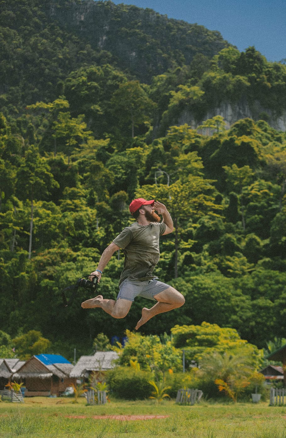 man jumping high holding camera, green, grass, trees, plant HD wallpaper