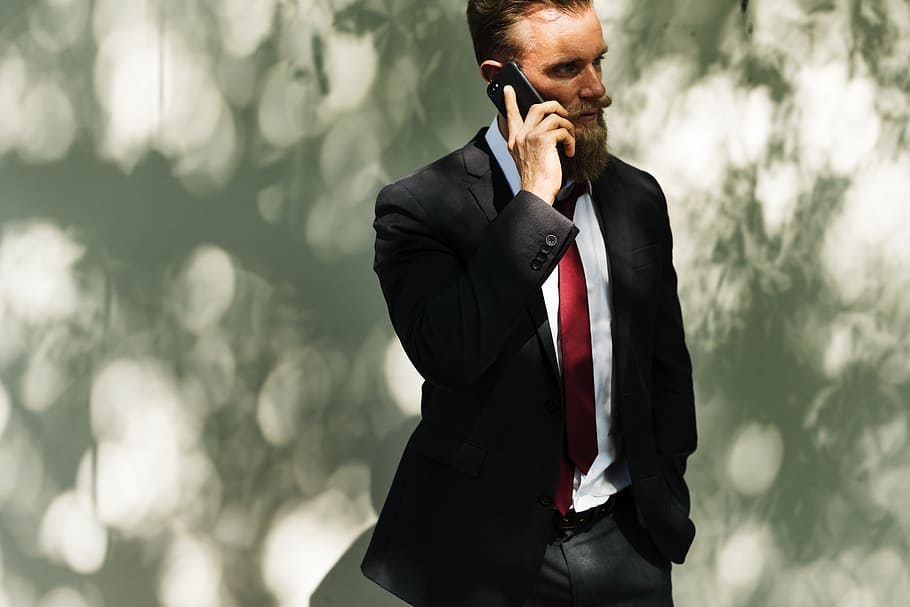 man in black blazer near white wall, beard, business, calling HD wallpaper
