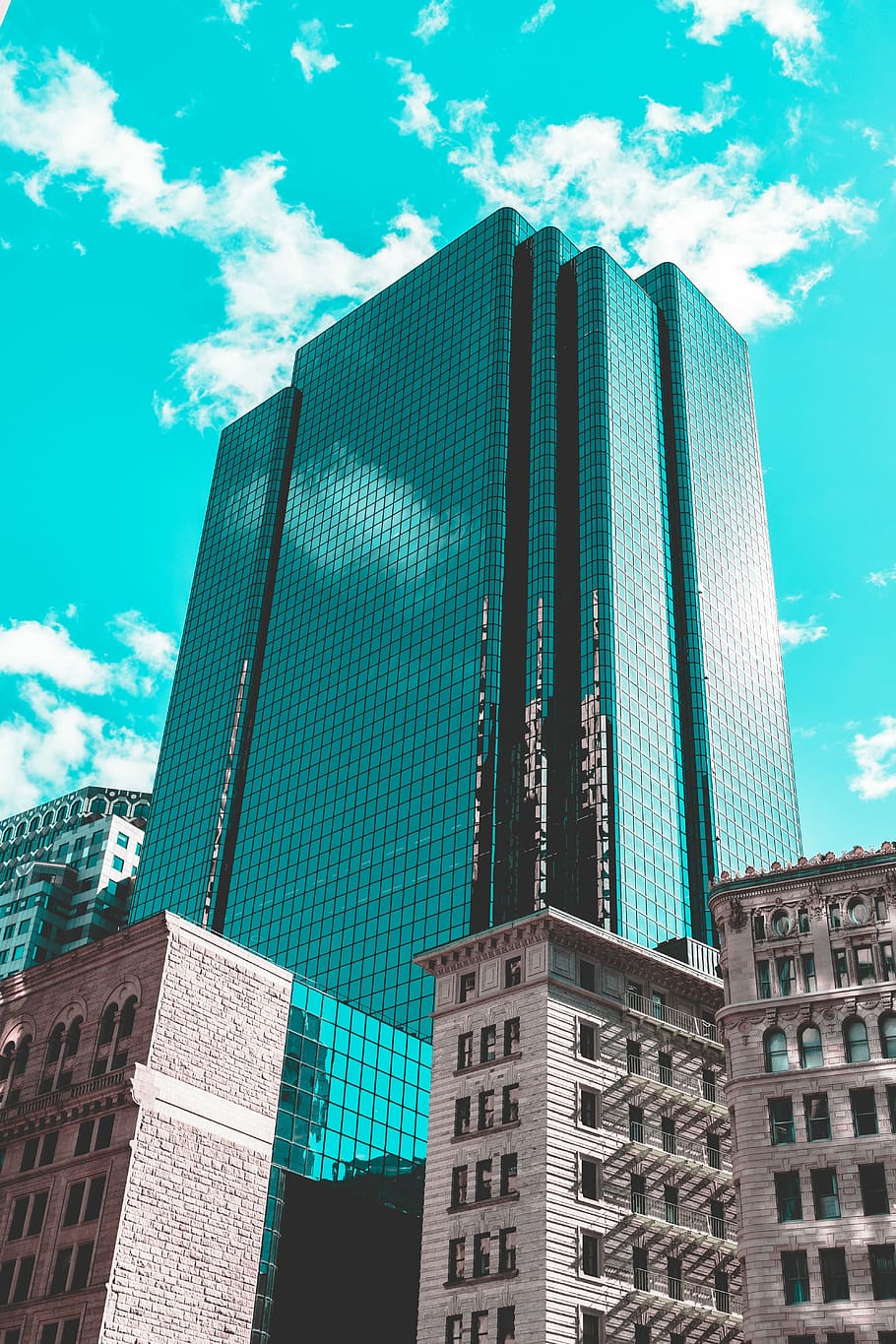 blue curtain wall building under teal skies, low-angle photography of high-rise building under clear blue sky during daytime HD wallpaper