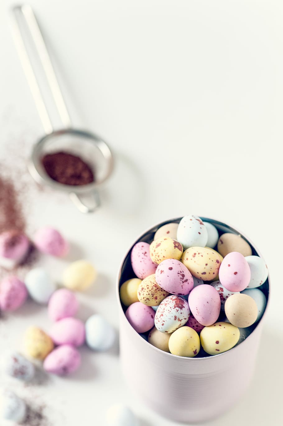 assorted-color quail eggs on can, egg candies on white container HD wallpaper