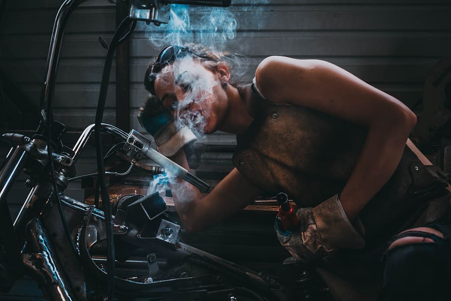 person blowing smoke, person leaning on black metal bar, Do, girl