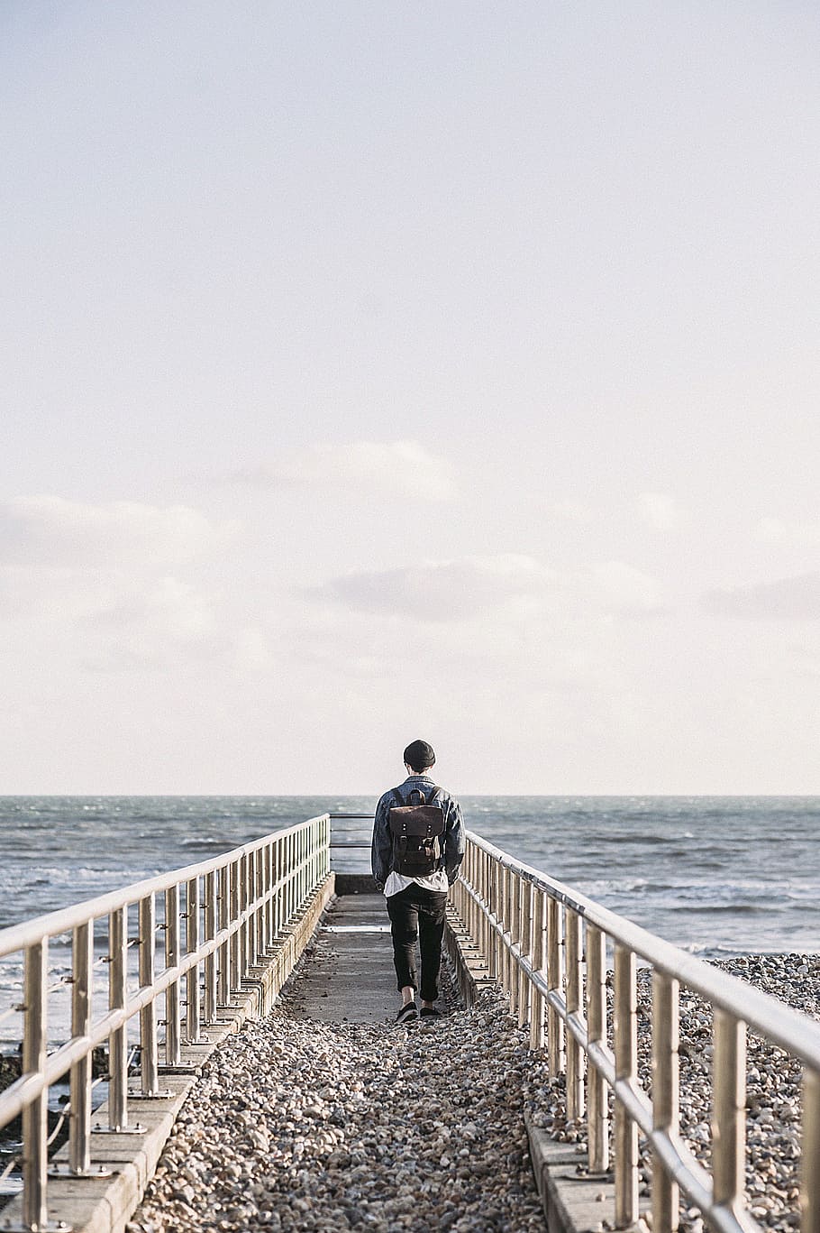 Man in Black Jacket Walking on Gray Concrete Dock, backpack, bag HD wallpaper