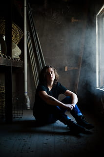 man sitting while resting his arms on his knee inside concrete building, woman sitting in wooden room HD wallpaper