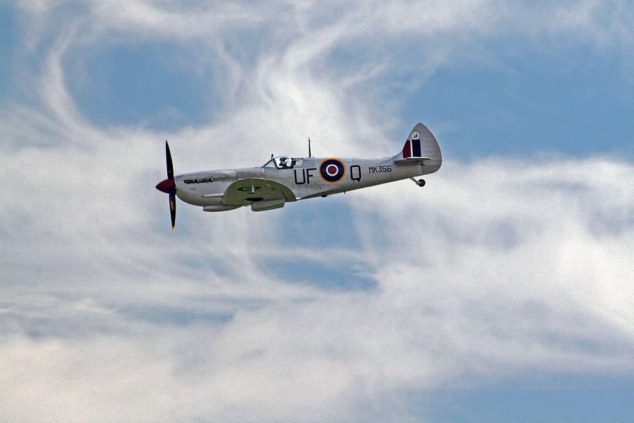 white and black UFO plane under blue sky at daytime, gray stunt plane on sky HD wallpaper