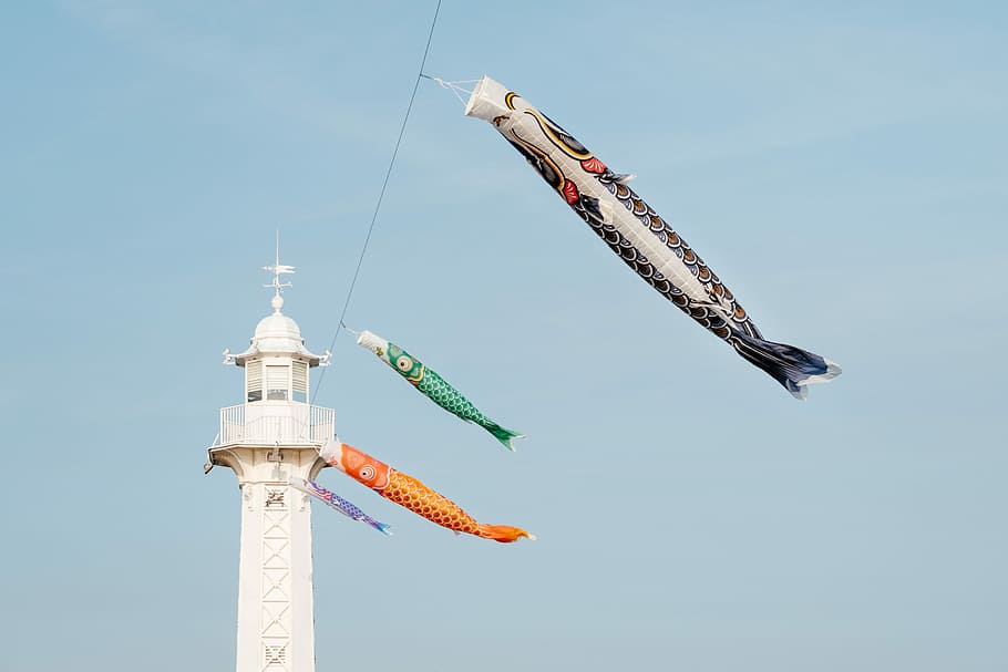 hanging koi fish banners near lighthouse, five inflatable fish hang on lighthouse HD wallpaper