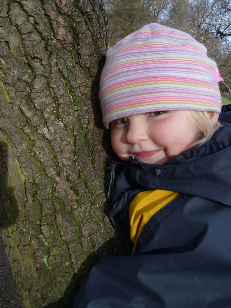 child, tree, autumn, tree bark, log, cap, joy, smile, rain jacket HD wallpaper