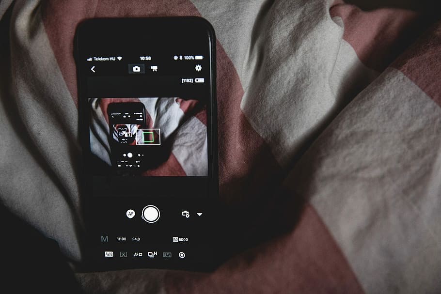 black Android smartphone on bed sheet, turned on black iPhone 7 HD wallpaper