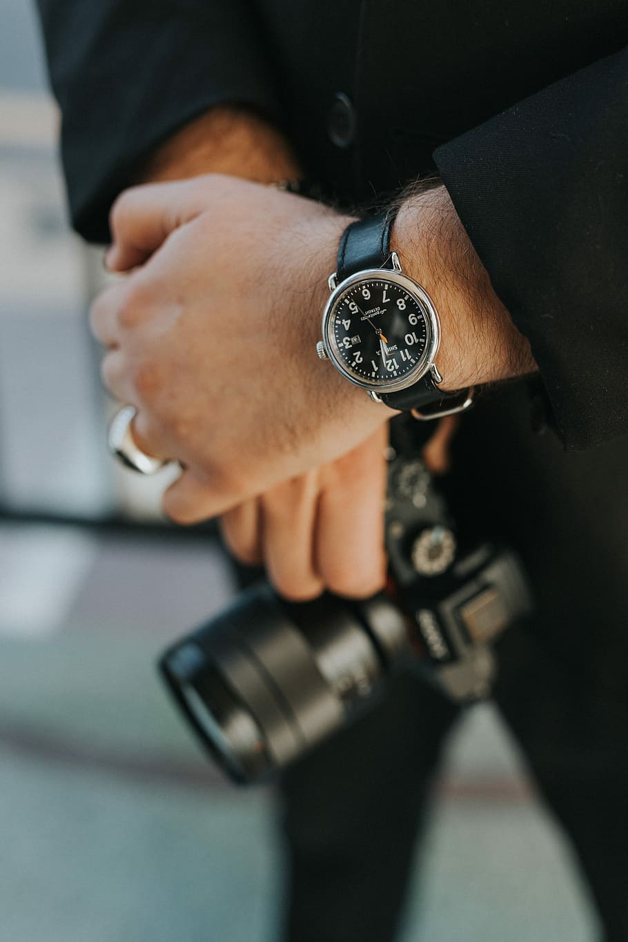 man wearing silver analog watch, person holding black DSLR camera with watch, HD wallpaper
